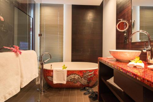 a bath room with a tub and a sink at Buddha-Bar Hotel Prague in Prague