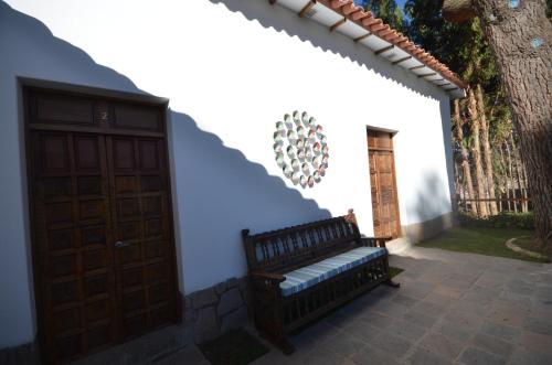 a bench in front of a building with a door at Palacio Manco Capac by Ananay Hotels in Cusco