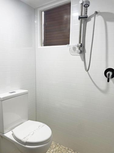 a bathroom with a toilet and a shower at Bongaree Ocean Villa in Bongaree