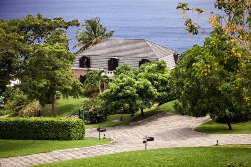 a house with the ocean in the background at Villas at Stonehaven in Black Rock