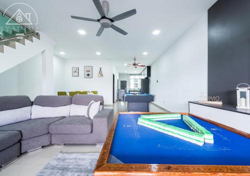 a living room with a couch and a pool at Port Dickson 14Pax 4BR Double Storey House in Port Dickson
