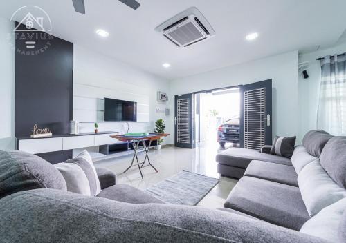 a living room with a couch and a kitchen at Port Dickson 14Pax 4BR Double Storey House in Port Dickson