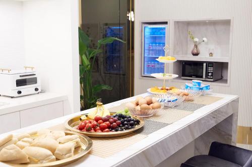 a table with various fruits and vegetables on it in a kitchen at 사직 덴바스타 시그니처 호텔 in Busan