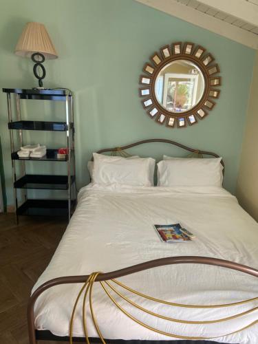 a bedroom with a bed with a mirror on the wall at Cozy studio with private spa in Oranjestad