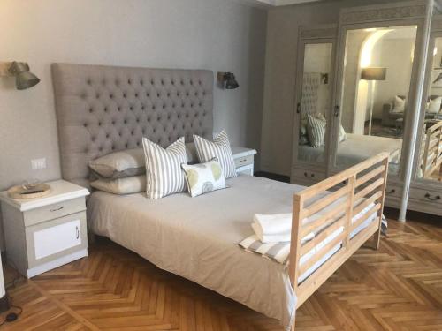 a bedroom with a large bed and a mirror at La Casa Verde B&B in Trivero