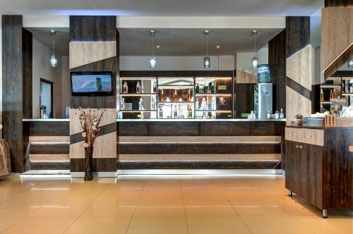 a lobby of a hotel with stairs and a bar at Aparthotel Hotel Prestige City II in Primorsko