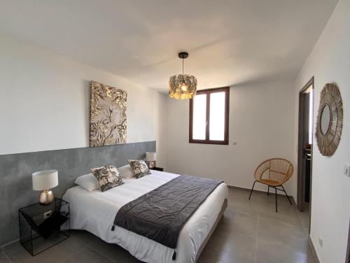 a bedroom with a large bed and a chandelier at La Listrella Residence & Spa in Monticello