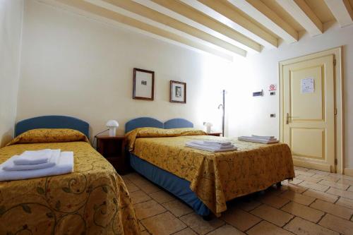 En eller flere senge i et værelse på Relais Villa Selvatico