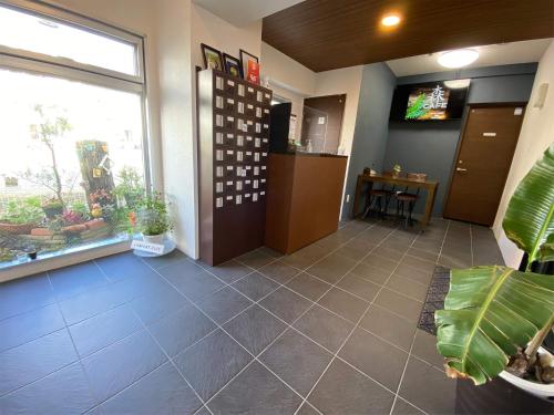 an office lobby with a large window and a table at Comfort Plus in Chatan