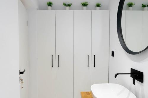 a bathroom with white cabinets and a mirror at Marilias Luxury Studio Apartment in Kissamos