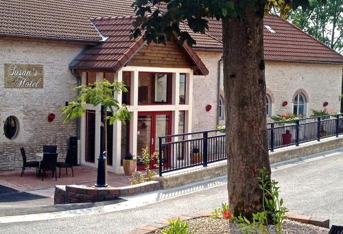 a building with a tree in front of it at Logis Hostellerie la Chaumière in Arsonval