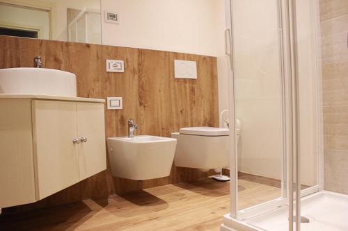 a bathroom with a sink and a toilet and a shower at Residence Elettra in Crone
