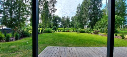 a view of a garden from a window at Brīvdienu māja ar Saunu in Saulkrasti