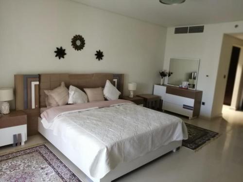 a bedroom with a large bed and a mirror at 2 BEDROOM in PALM JUMEIRAH CRESCENT BALQIS RESIDENCE DIRECT BEACH ACCESS in Dubai