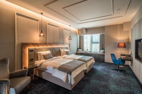 En eller flere senger på et rom på Sky Blue Hotel & Spa
