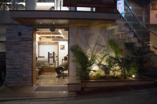 a man sitting in a chair in an office at Hotel SRI SRI EXECUTIVE KOLHAPUR NEAR MAHALAXMI TEMPLE in Kolhapur