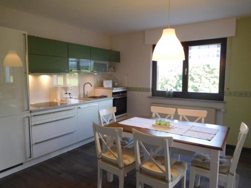 a kitchen with a table and chairs in a kitchen at Ferienwohnung Charly in Hellenthal