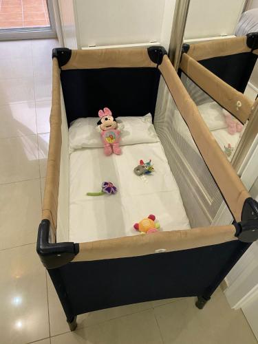 a baby crib with three stuffed animals on it at BADAROSA House10min to BARCELONA City&NearTo BEACH in Badalona
