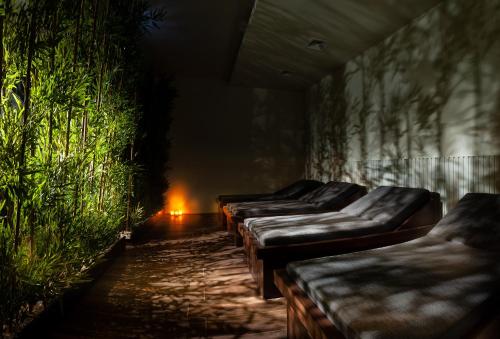a row of beds in a room with plants at TNR Otel & Spa in Kusadası