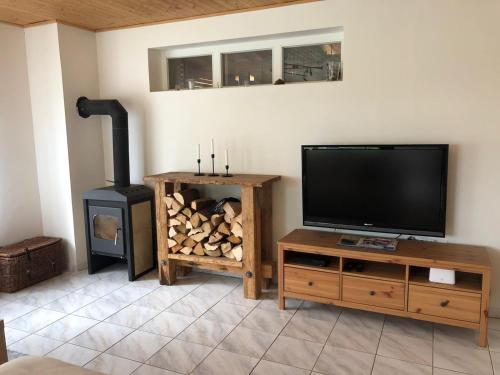 a living room with a flat screen tv and a wood stove at Ubytování na Čechách in Děčín