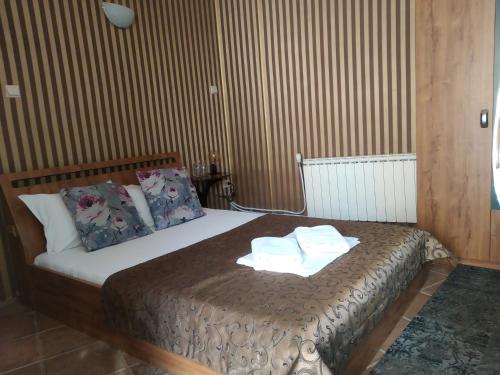 a bedroom with a bed with towels on it at Hotel Perfect in Varna City