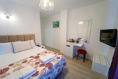 a bedroom with a bed and a mirror and a television at Tepehan by Özkul in Izmir