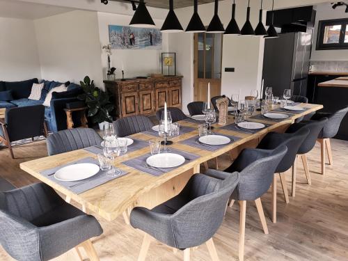 a large wooden table with chairs and a long table at Chalet Domisiladoré - chalet haut de gamme pour 10 adultes et 2 enfants à Châtel in Châtel