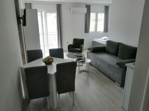 a living room with a couch and a table at Vila Leolaz in Višegrad