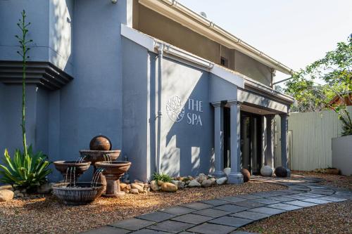 a blue building with a sign on the side of it at Silver Forest Boutique Hotel and Spa in Somerset West