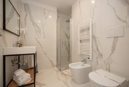 a bathroom with a toilet and a shower and a sink at Hotel Marconi Express in Bologna