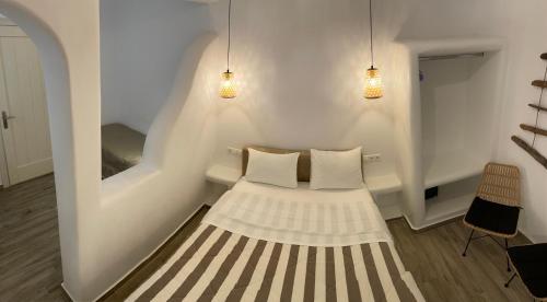 a small room with a bed with two pillows at Theofanis Studios in Agia Anna Naxos