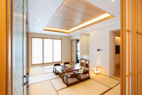 a living room with a table and chairs and a ceiling at Tomonoya Hotel & Ryokan Daecheon in Boryeong