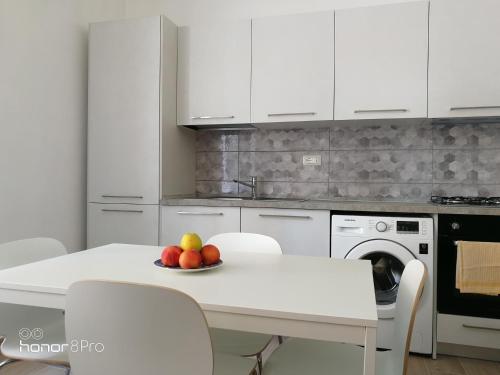 a kitchen with a table with a bowl of fruit on it at Casa Viorica 2 in Ancona