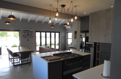 a large kitchen with a stove and a dining room at Comfort in Langebaan in Langebaan