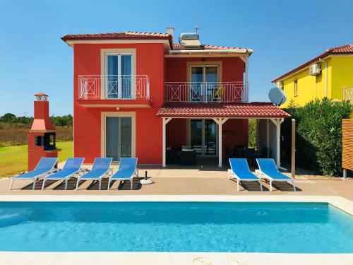 una villa con piscina di fronte a una casa di Iridia Resort Villas a Foiníki