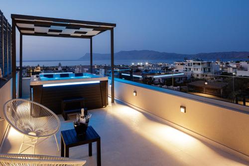 a balcony with a view of a city at night at Sapphire Blue Suites in Kissamos
