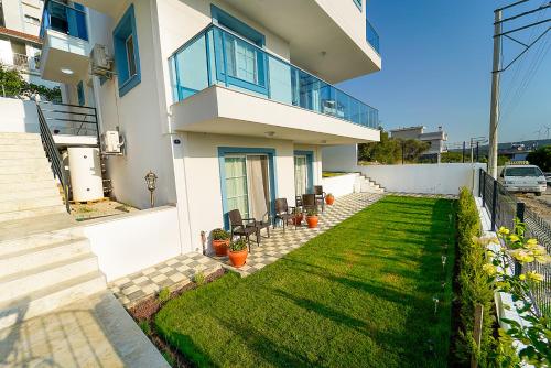 a house with a lawn in front of it at Tepehan by Özkul in Izmir