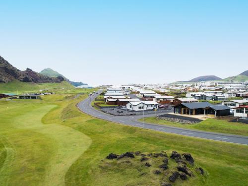 an aerial view of a town with a winding road at Luxury Ocean Villas in Vestmannaeyjar