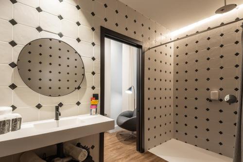 a bathroom with a sink and a mirror at TOC Hostel Malaga in Málaga