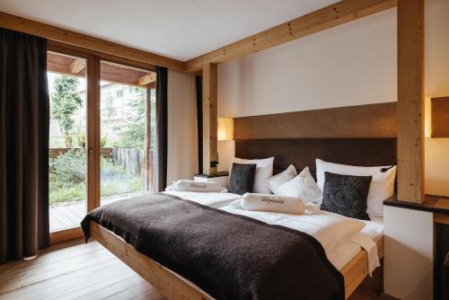 Postel nebo postele na pokoji v ubytování Lagació Hotel Mountain Residence
