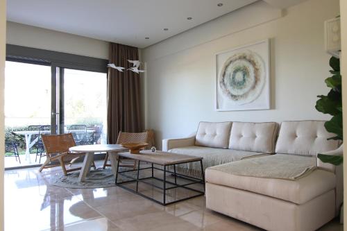 a living room with a couch and a table at Hanioti suite maisonette in front of the sea in Hanioti
