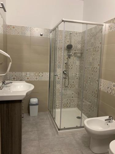a bathroom with a shower and a sink and a toilet at Le Stanze della Braceria Calabrese in Scilla