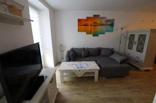 a living room with a couch and a table at Gästewohnung "ALTE SPINNEREI" in Kirchberg