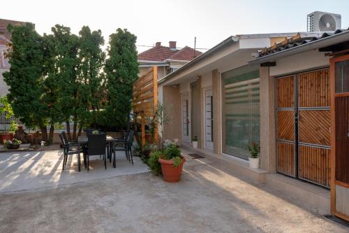 a patio of a house with a table and chairs at Prestige Apartments in Niš