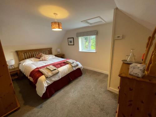 a bedroom with a bed and a window at 1 & 2 Foundry Cottages in Sutton Maddock