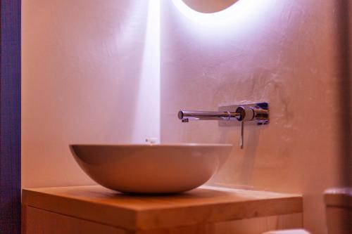 a bowl sitting on top of a wooden table at Toni Retzo Rooms in Himare