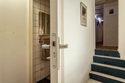 a door leading to a bathroom with stairs at B&B 1971 Hazenstraat - Shared Bathroom in Amsterdam