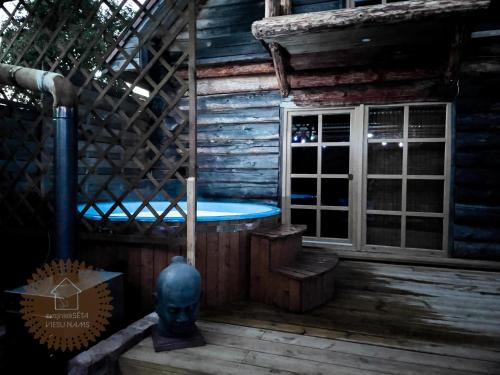 a room with a tub in a wooden house at Guest house Zvejnieksēta in Pāvilosta
