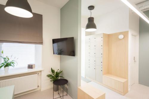 a living room with a tv on a wall at CAPSULE HOTEL & HOSTEL in Kharkiv