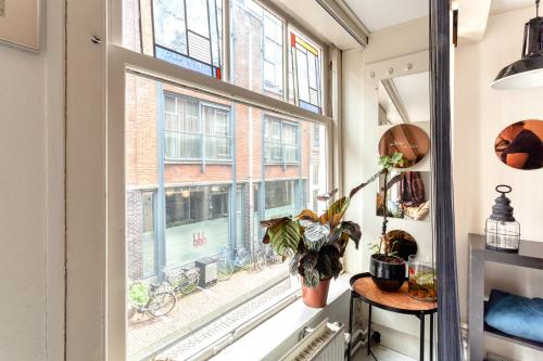 a room with a window with a plant on it at B&B 1971 Hazenstraat - Shared Bathroom in Amsterdam